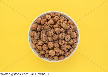 Chufa, Tigernut, Earth Almond On Ceramic Bowl On Yellow Background. Healthy Organic Food Concept. Ti