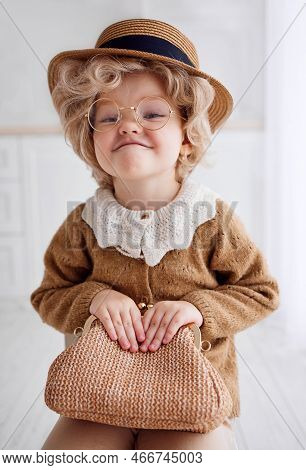 Portrait Of Cute Baby Girl Cosplaying A Grumpy Old Lady. Carnival Costume Party