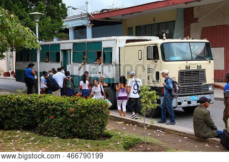 Holguin, Cuba - February 16, 2011: Cubans Board A Semi-trailer City Bus In Holguin. Cuba Trade Embar