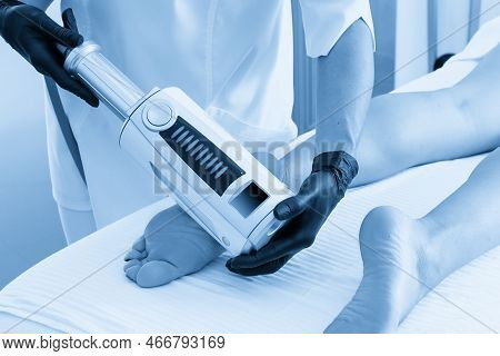 Cosmetologist In Rubber Gloves Doing Endospheres Therapy On Female Feet