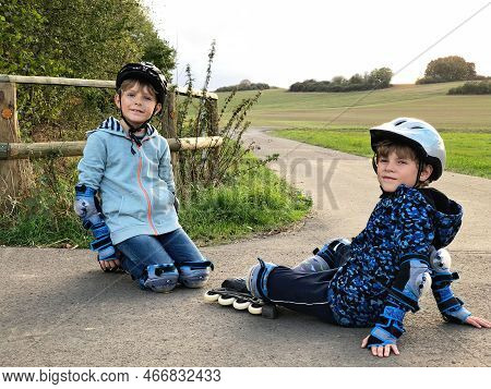 Two Little Kids Boys Skating With Rollers In The City. Happy Children, Siblings And Best Friends In 