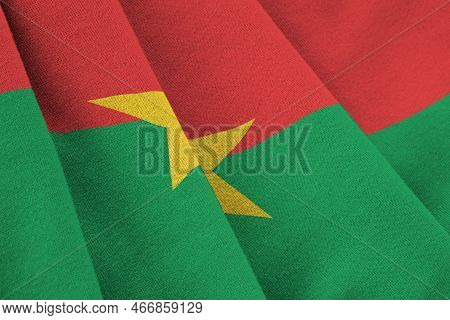 Burkina Faso Flag With Big Folds Waving Close Up Under The Studio Light Indoors. The Official Symbol