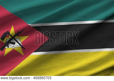 Mozambique Flag With Big Folds Waving Close Up Under The Studio Light Indoors. The Official Symbols 