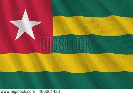 Togo Flag With Big Folds Waving Close Up Under The Studio Light Indoors. The Official Symbols And Co