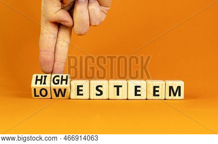 High Or Low Esteem Symbol. Concept Words High Esteem And Low Esteem On Wooden Cubes. Businessman Han