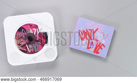 1st Music Album Of K-pop Group Itzy Crazy In Love On Grey Background. Pink Music Cd In White Retro P