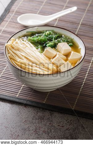 Japanese Vegetarian Shiro Miso Soup With Tofu, Enoki Mushrooms, Wakame Seaweed Close-up In A Bowl On