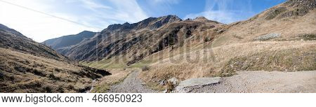 Alpine Terrain In East Tyrol Austria With Gravel Road Between Mountain Ranges Against Partly Cloudy 
