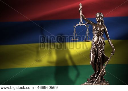 Mauritius Flag With Statue Of Lady Justice And Judicial Scales In Dark Room. Concept Of Judgement An