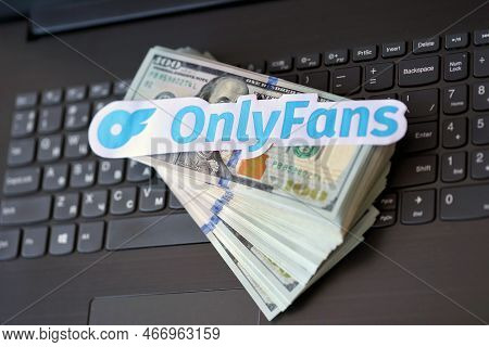 Ternopil, Ukraine - September 6, 2022 Onlyfans Paper Logotype On Bunch Of Us Dollar Bills Lies On Bl