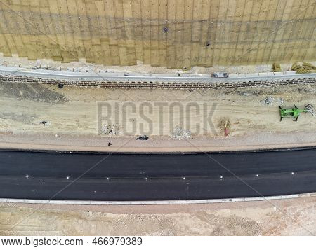 Mountain Road Constraction. Workers Reinforce The Slope Over The New Road. Road Construction In Prog