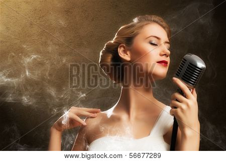 beautiful blonde woman singer with a microphone