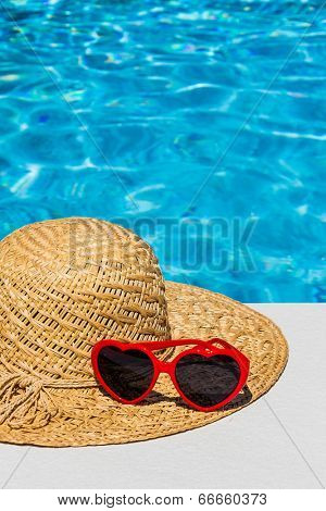 utensils for a nice and relaxing vacation day lying next to a swimming pool. relaxation on holiday.