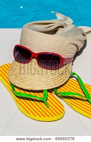 utensils for a nice and relaxing vacation day lying next to a swimming pool. relaxation on holiday.
