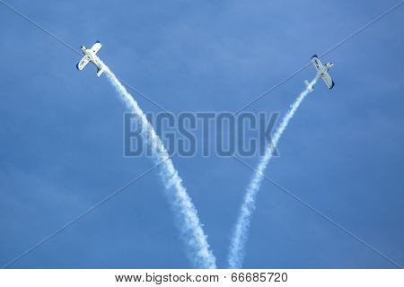 BERLIN, GERMANY - MAY 21, 2014: Aerobatic team 3x Fly Sinthesis Texan Top Class (Wefly team, Italy) demonstration during the International Aerospace Exhibition ILA Berlin Air Show-2014.
