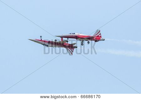 BERLIN, GERMANY - MAY 20, 2014: Aerobatic team Northrop F-5E Tiger II (Patrouille Swiss) demonstration during the International Aerospace Exhibition ILA Berlin Air Show-2014.