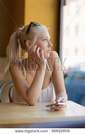 Thoughtful teenage girl looking out the window
