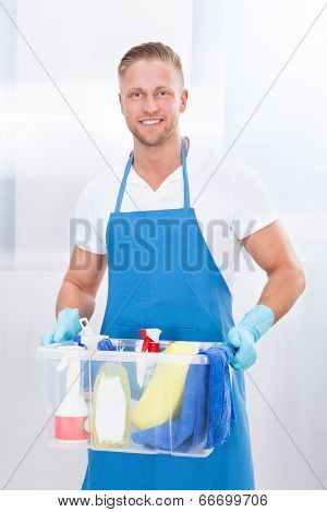 Happy Janitor With A Tub Of Cleaning Supplies