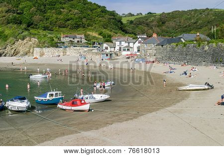 Tourists And Boats On The Sandy Beach Of Polkerris A Famous