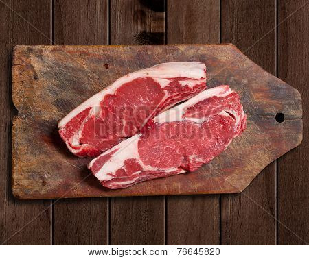 Raw Meat On Wooden Table.