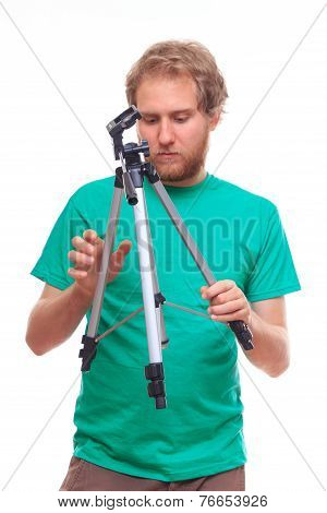 Man Unfolding A Tripod