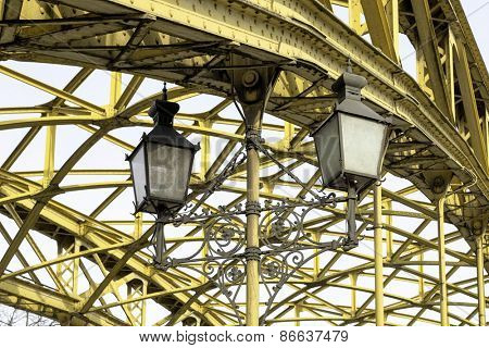 Decorative lamps hanging from old bridge