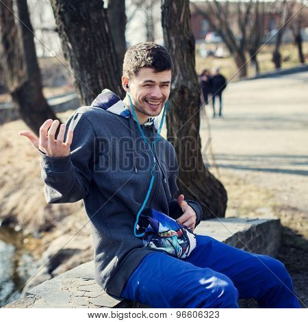 handsome young man playing the guitar imaginary and listening to music