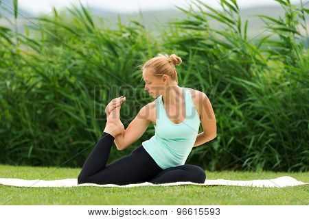 Woman Making Yoga One Legged King Pigeon Pose
