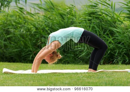 Young Woman Doing Bridge Pose In Yoga