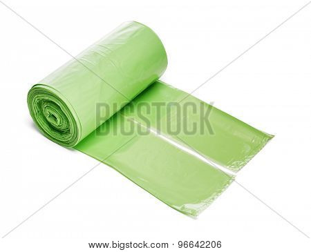 Roll of green plastic trashbags isolated on white with naturan shadow.