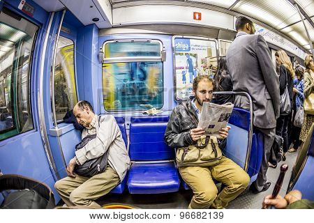 Tourists And Locals On A Subway Train Line 8 In Paris
