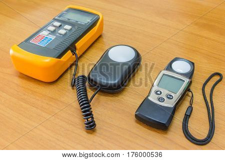 Lux meter for measuring light intensity isolated on wooden background