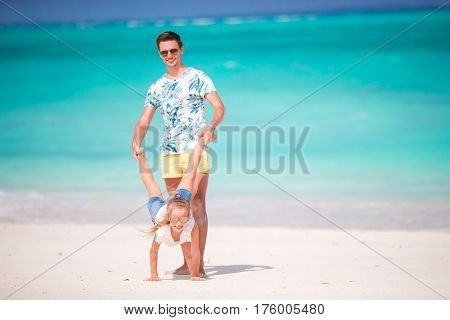 Happy father and his adorable little daughter enjoy summer vacation