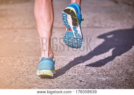 Running athlete during training outdoors in the summer on a sunny day.