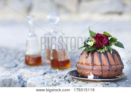 Cocolate cake and three whiskey decanters against a light gray background with copy space