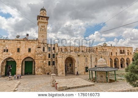 JERUSALEM, ISRAEL - MAY 23, 2016: Tourists visiting the Dome of the Rock and Bab el Ghawanimeh Mosque, an Islamic shrine located on the Temple Mount in the Old City.