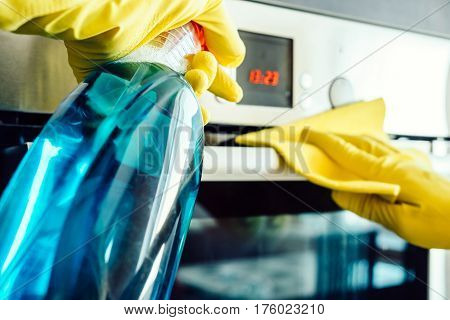 Man's Hand In Glove With Rag Cleaning Oven