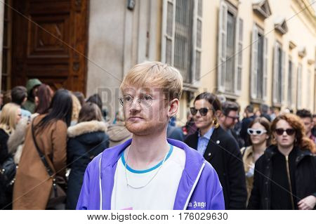MILAN ITALY - FEBRUARY 25: Fashionable man poses outside Blumarine fashion show during Milan Women's Fashion Week on FEBRUARY 25 2017 in Milan.