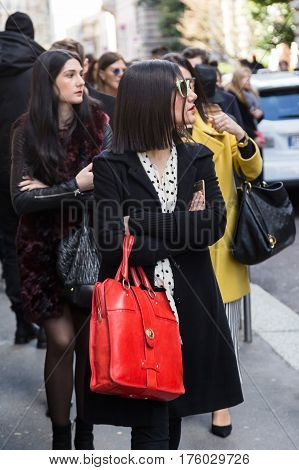 MILAN ITALY - FEBRUARY 25: Fashionable woman poses outside Blumarine fashion show during Milan Women's Fashion Week on FEBRUARY 25 2017 in Milan.