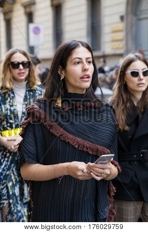 MILAN ITALY - FEBRUARY 25: Fashionable woman poses outside Blumarine fashion show during Milan Women's Fashion Week on FEBRUARY 25 2017 in Milan.