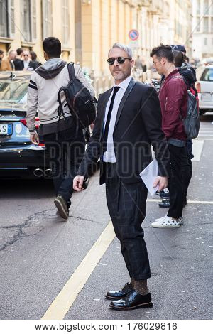 MILAN ITALY - FEBRUARY 25: Fashionable man poses outside Blumarine fashion show during Milan Women's Fashion Week on FEBRUARY 25 2017 in Milan.