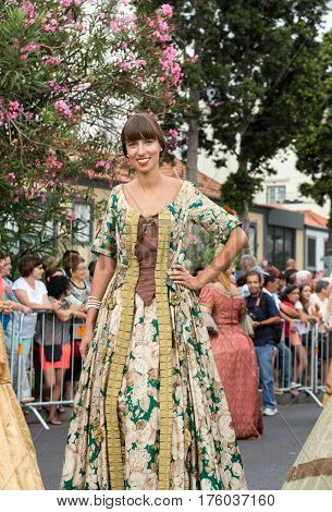 FUNCHAL MADEIRA PORTUGAL - SEPTEMBER 4 2016: Woman in historical fashion dress durnig historical and ethnographic parade of Madeira Wine Festival in Funchal. Madeira Portugal
