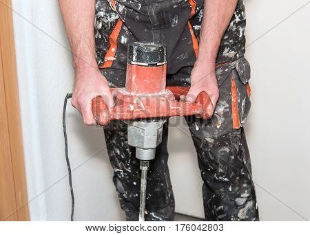 Workers Mixing The Adhesive In Construction