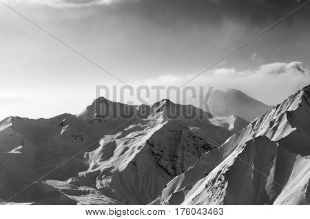 Black And White View On Snowy Sunlight Mountains In Early Fog Morning