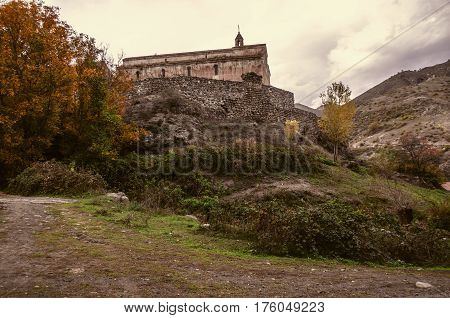 Perched high in the mountains monastery for old stone wall in the autumn overcast day