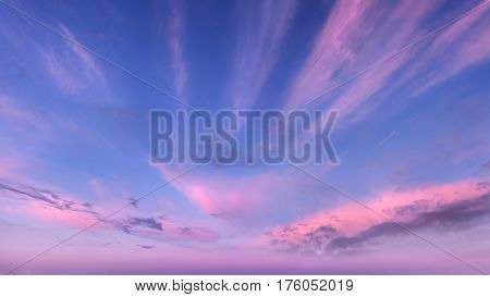Soft fluffy and colorful cloud formation as background taken at dawn.