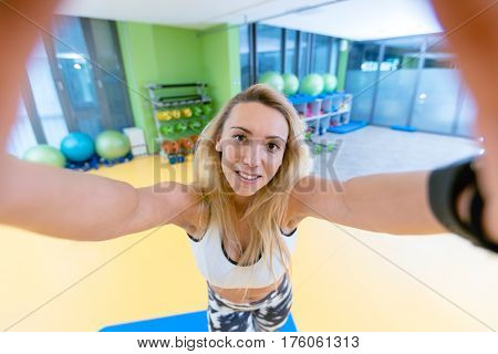 sport woman smile at camera self picture at gym, young girl picture herself exercising fitness center.