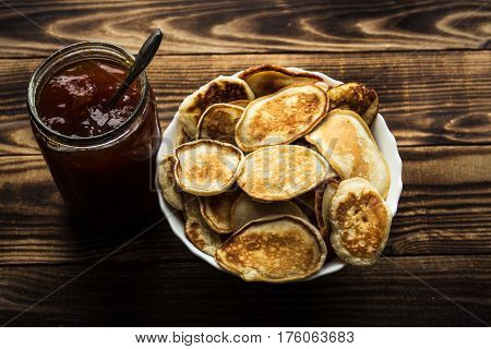 the homemade vegan pancackes with jam wooden background