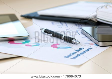 Mobile Business Background with color printed professional Chart and hand written Scheme on piece of Paper and digital Gadgets screens on Vintage sepia toned Desk