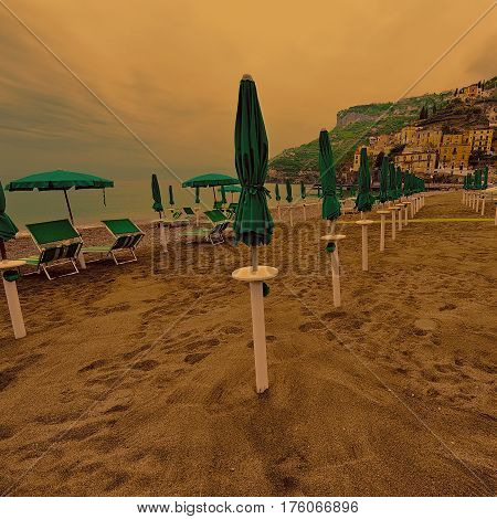 Beach Umbrellas on the Background of the Italian City of Minori at Sunset